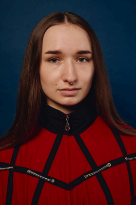 Studio portrait of a young person with long brown hair